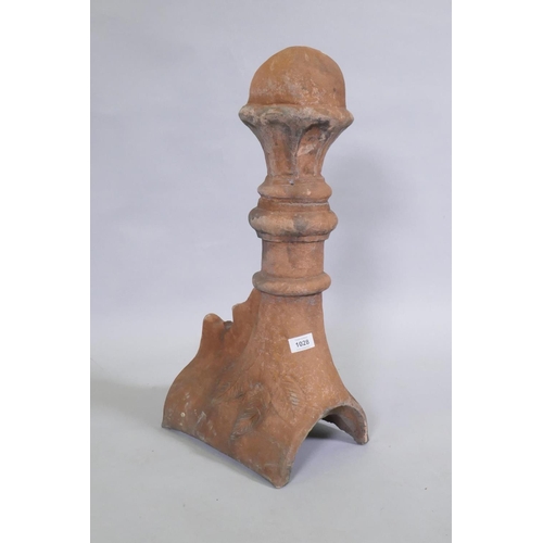 1147 - A terracotta ridge tile finial, 63cm high