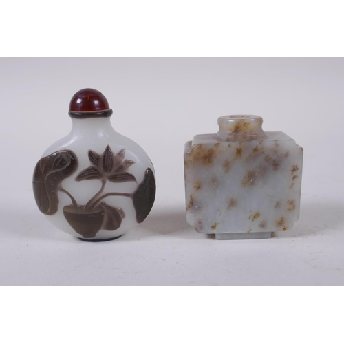 343 - A Peking glass snuff bottle with carved decoration of a potted lotus flower, and a carved hardstone ... 