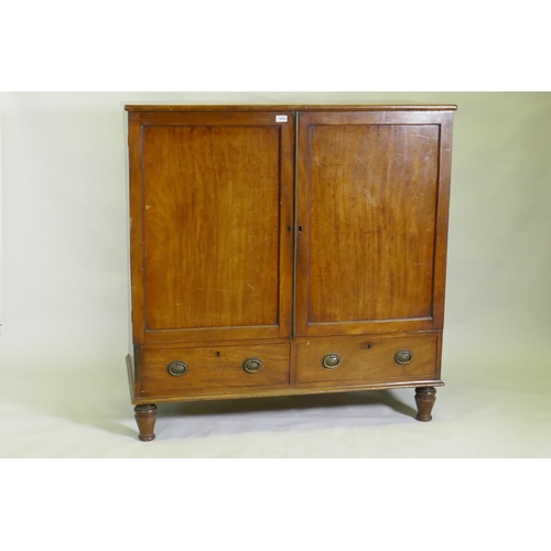 1003 - A Regency mahogany press cupboard, with two doors opening to reveal slide drawers over a single draw... 