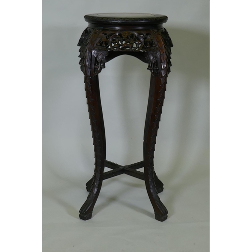 1017 - A tall Chinese hardwood jardiniere stand with shaped top inset with marble, with carved and pierced ... 