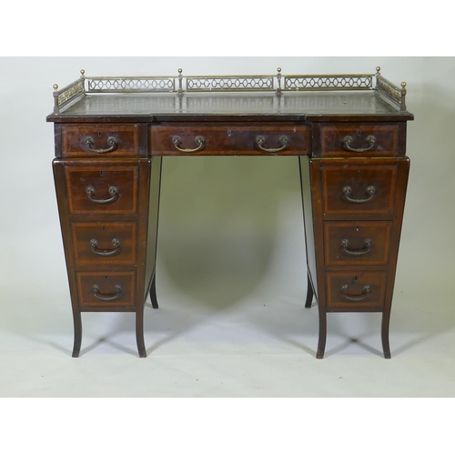 1020 - A Victorian Edwards and Roberts mahogany nine drawer pedestal desk with three quarter pierced brass ... 