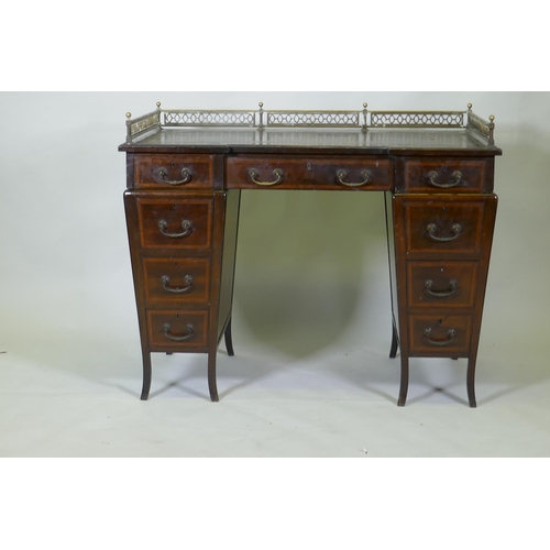 1020 - A Victorian Edwards and Roberts mahogany nine drawer pedestal desk with three quarter pierced brass ... 