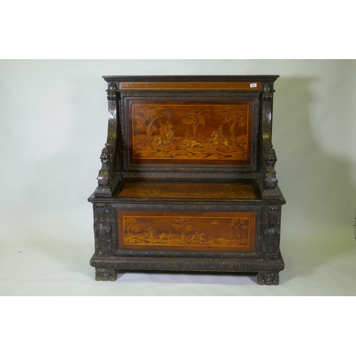 1021 - An early C19th Continental marquetry inlaid settle, the seat back and front panel decorated with hun... 