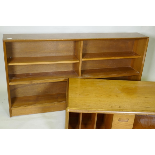 1029 - A mid century walnut bookcase with sliding glass doors, 153 x 25 x 84cm, and a teak media unit