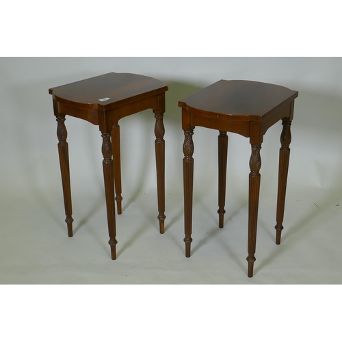 1034 - A pair of inlaid mahogany end tables, with shaped tops, raised on fluted tapering supports, 32 x 49 ... 