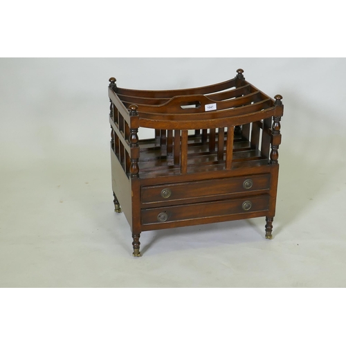 1041 - A C19th mahogany canterbury with two drawers, raised on turned supports with brass castors, 49 x 35 ... 