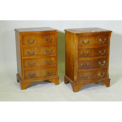 1042 - A pair of serpentine front yew wood veneered bedside chests of four drawers with brass handles, rais... 