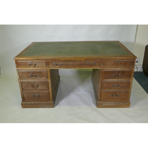 1046 - A mid C20th mahogany veneered eight drawer pedestal desk with brass swan neck handles and leather in... 