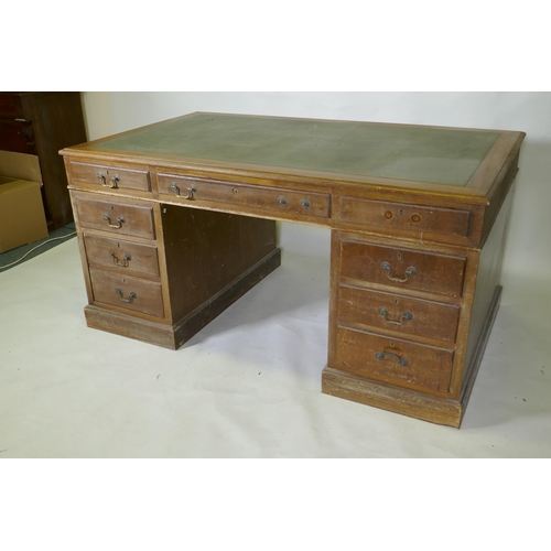 1046 - A mid C20th mahogany veneered eight drawer pedestal desk with brass swan neck handles and leather in... 