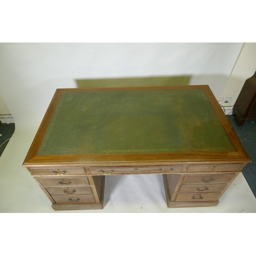 1046 - A mid C20th mahogany veneered eight drawer pedestal desk with brass swan neck handles and leather in... 