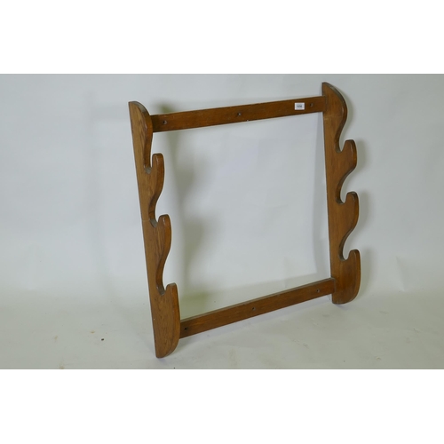 1056 - A vintage oak gun rack, 72 x 77 x 14cm