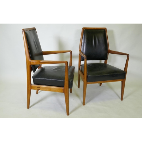 1059 - A set of three mid century teak boardroom elbow chairs with leather upholstered seats and backs