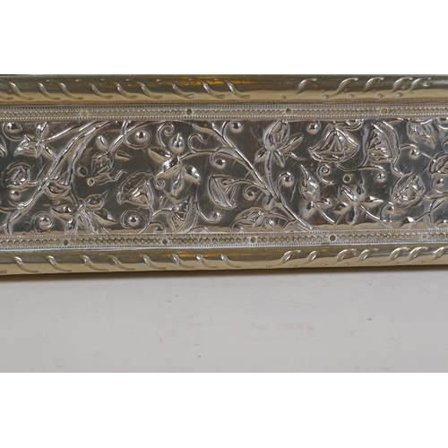 1065 - A Moorish white metal mirror with repousse floral decoration, 61 x 77cm