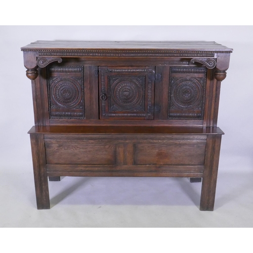 1067 - Late C18th/early C19th French oak side/food cupboard, with triple panel front and single door, carve... 