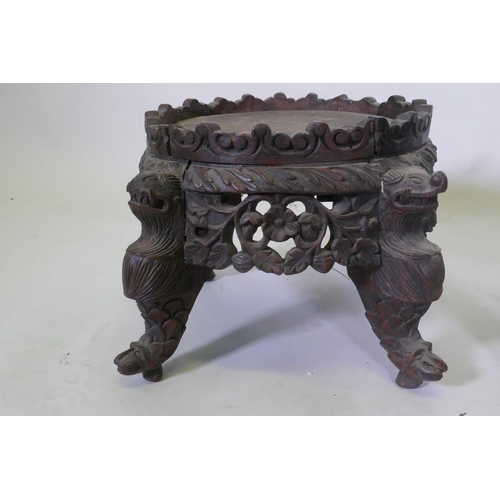 1069 - A C19th oriental hardwood stand, with carved and pierced frieze, raised on dragon supports, possibly... 