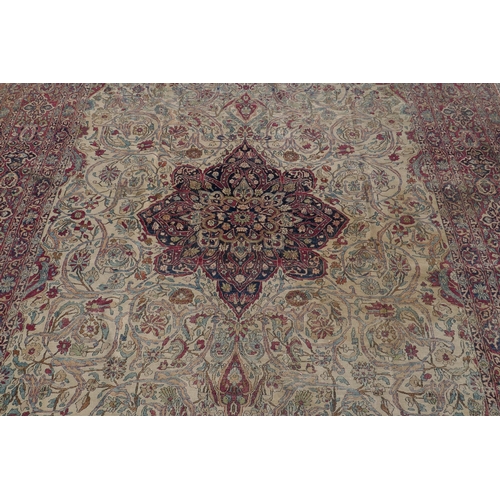 1071 - An antique Persian carpet, medallion design on a red field, pile worn/20cm tear, 270 x 362cm