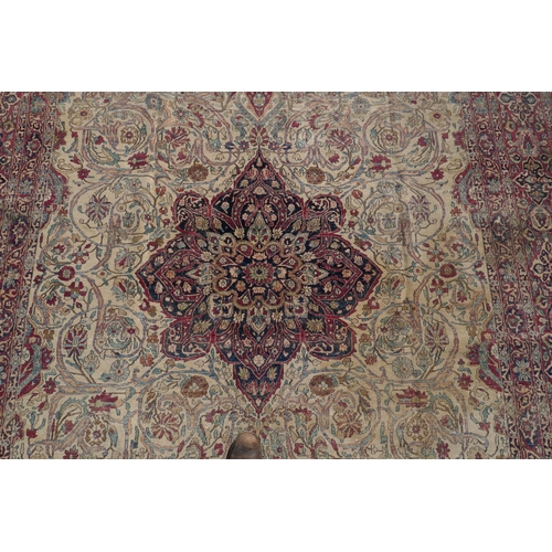 1071 - An antique Persian carpet, medallion design on a red field, pile worn/20cm tear, 270 x 362cm