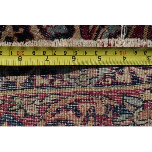 1071 - An antique Persian carpet, medallion design on a red field, pile worn/20cm tear, 270 x 362cm