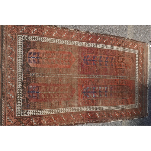 1073 - An antique Turkish rust ground wool rug, 90 x 160cm