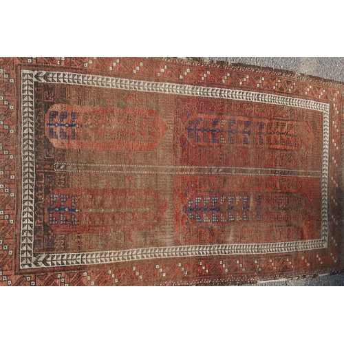 1073 - An antique Turkish rust ground wool rug, 90 x 160cm