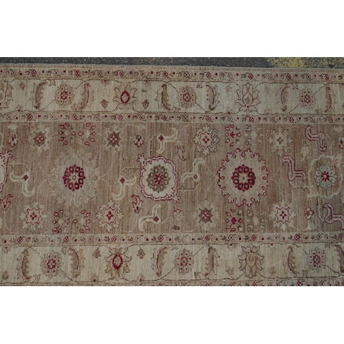 1074 - A cream ground wool Ziegler Mahal runner decorated with floral medallions, 85 x 350cm