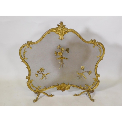 1076 - A rococo style brass firescreen with applied floral decoration, 74 x 68cm