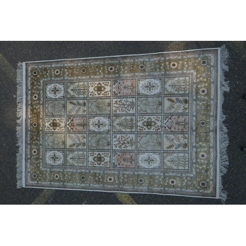 1081 - An ivory ground silk Kashan rug with panelled garden design, signed, 126 x 184cm