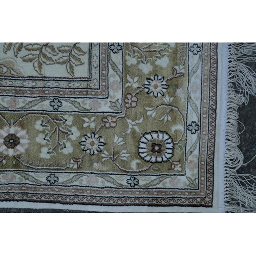 1081 - An ivory ground silk Kashan rug with panelled garden design, signed, 126 x 184cm