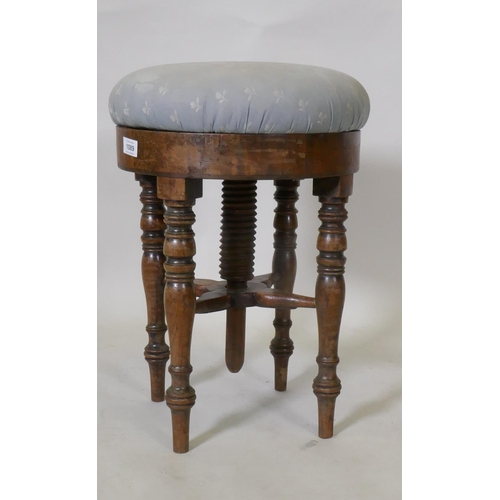 1089 - An early C19th mahogany revolving piano stool, 50cm high