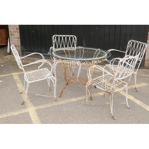 1092 - A vintage French wrought iron garden/bistro table and four chairs, early/mid C20th, table 87cm diame... 