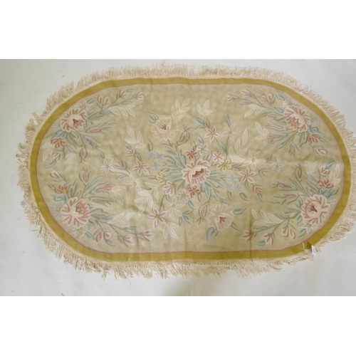 1103 - A Chinese embroidered rug with floral decoration, on a gold ground, 155 x 100cm