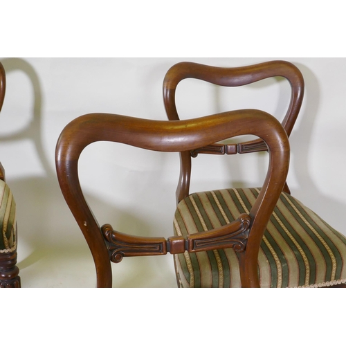 1106 - Set of four C19th mahogany kidney back chairs raised on turned reeded supports, stamped James Winter... 