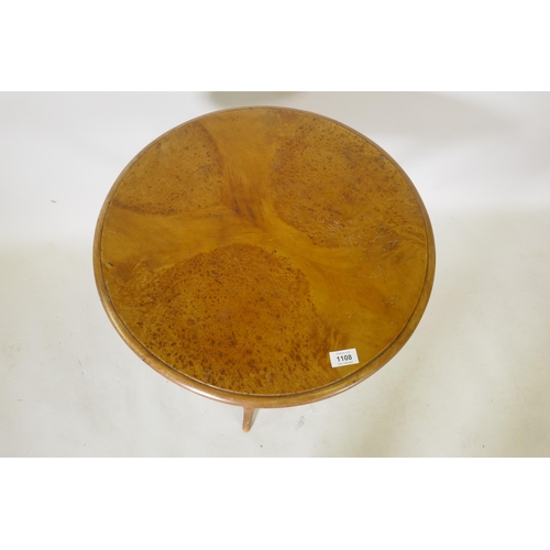 1108 - A C19th burr yew wood gypsy table, raised on crossed bobbin turned supports, 54cm diameter, 62cm hig... 