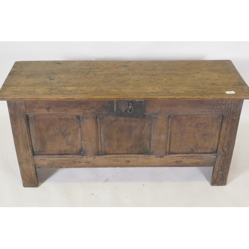 1111 - Early C18th oak triple panel oak coffer, with planked top and ends, raised on stile supports, 112 x ... 