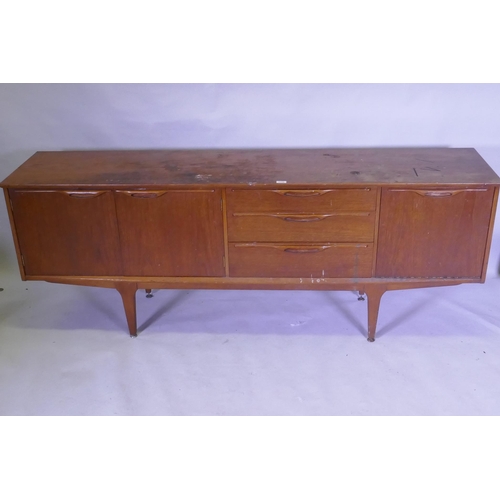 1112 - A mid century teak sideboard with two cupboards flanking three drawers, top AF, 45 x 196 x 75cm