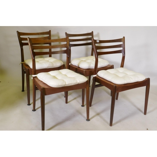 1118 - A set of four mid century mahogany dining chairs with squab cushions