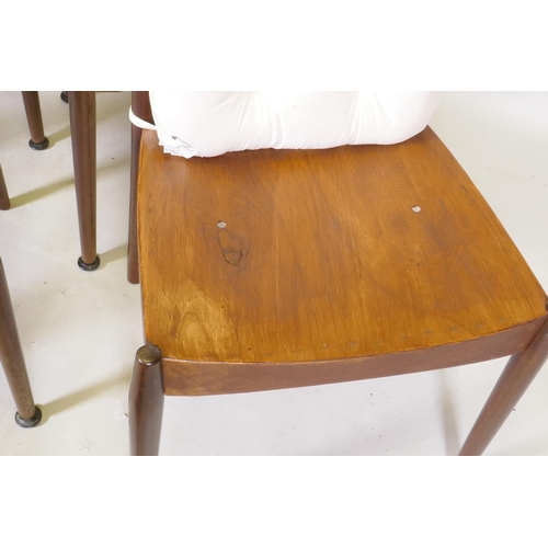 1118 - A set of four mid century mahogany dining chairs with squab cushions