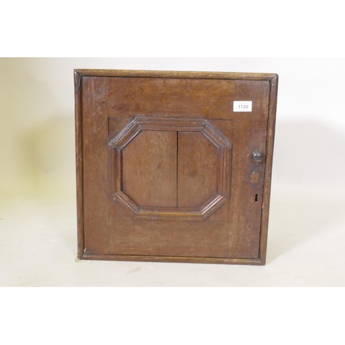 1120 - A late C17th/early C18th oak spice cupboard with moulded panel door, 43 x 22 x 4cm