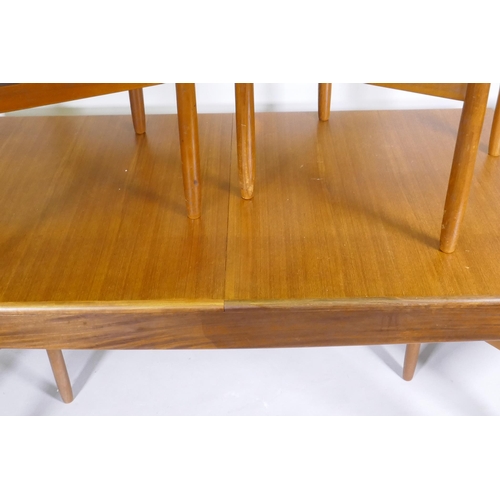 1128 - A mid century teak extending dining table, with folding leaf, designed by John Herbert for A. Younge... 