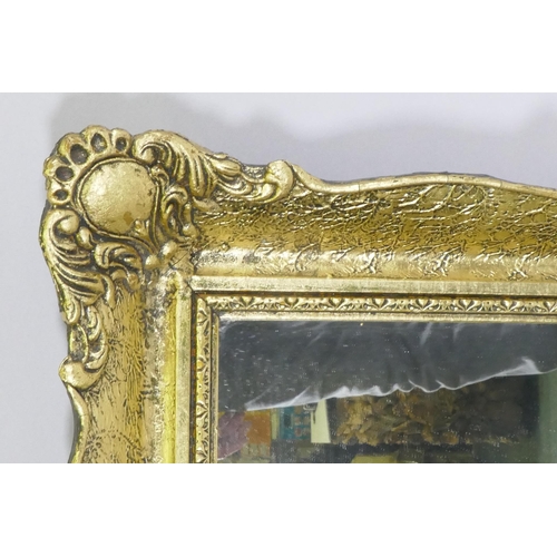 1143 - A gilt composition wall mirror with swept frame, 63 x 79cm