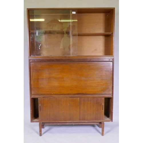 1146 - A mid century Beaver & Tapley Ltd multi width teak unit in two sections, the upper with sliding ... 