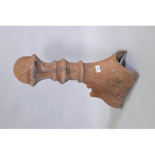 1147 - A terracotta ridge tile finial, 63cm high