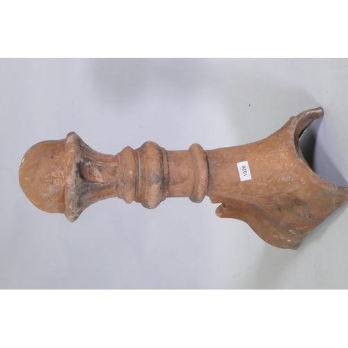 1147 - A terracotta ridge tile finial, 63cm high