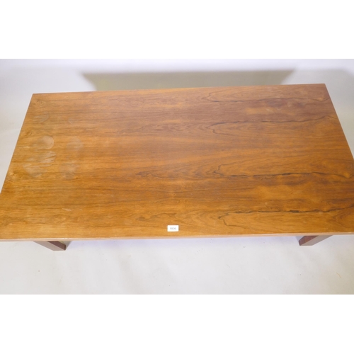 1151 - A mid century rosewood coffee table raised on square supports, 70 x 138 x 45cm