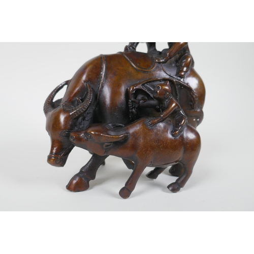 116 - A Chinese filled bronze figure group of children playing on a buffalo, 18cm high