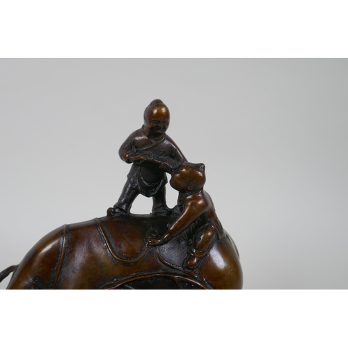 116 - A Chinese filled bronze figure group of children playing on a buffalo, 18cm high