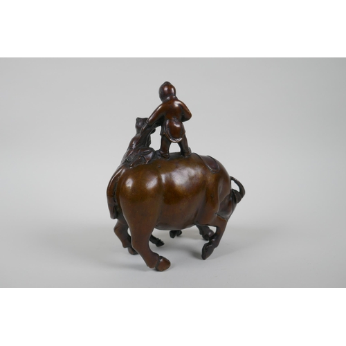 116 - A Chinese filled bronze figure group of children playing on a buffalo, 18cm high