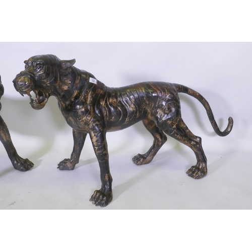 123 - A pair of Chinese bronze life size tiger cubs with the remnants of gilt patina, 114cm long