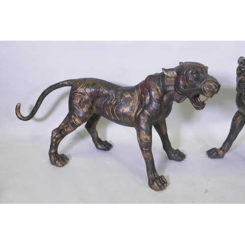 123 - A pair of Chinese bronze life size tiger cubs with the remnants of gilt patina, 114cm long