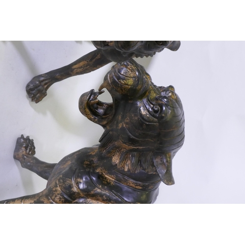 123 - A pair of Chinese bronze life size tiger cubs with the remnants of gilt patina, 114cm long